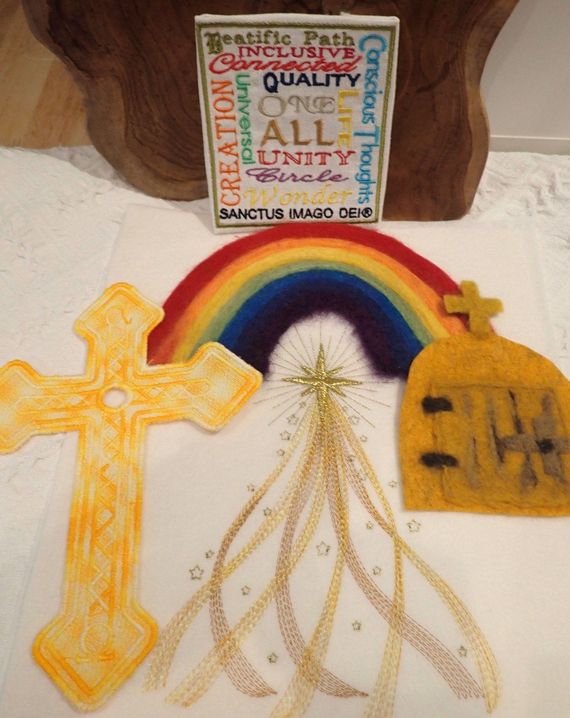 A drawing of a cross a rainbow and a sign that says all unity