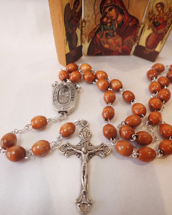 A rosary with wooden beads and a cross on it