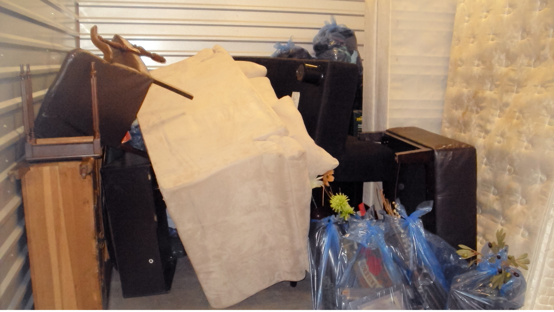 A room with a lot of stuff in it including a mattress
