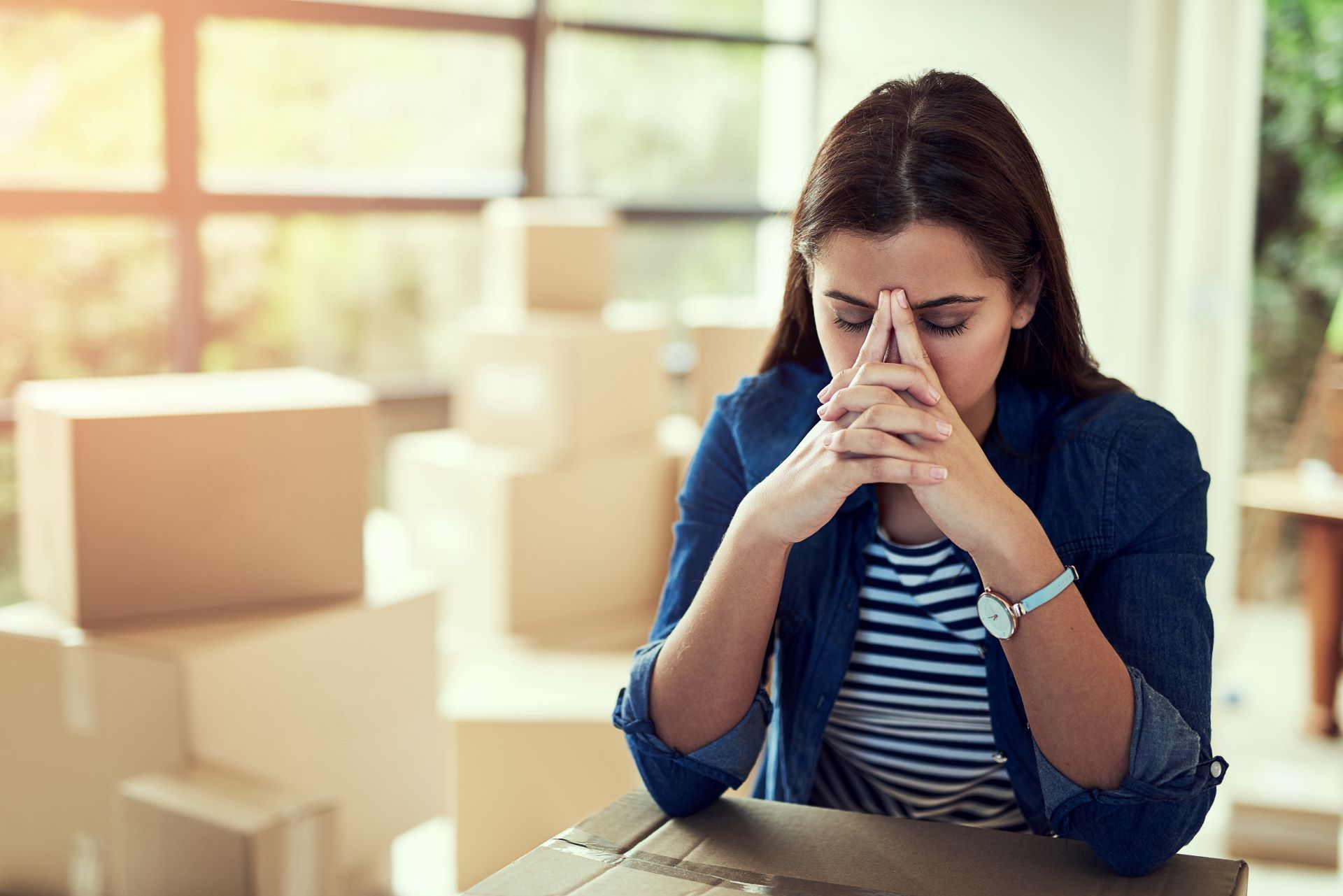 woman stressed among boxes during an estate cleanout