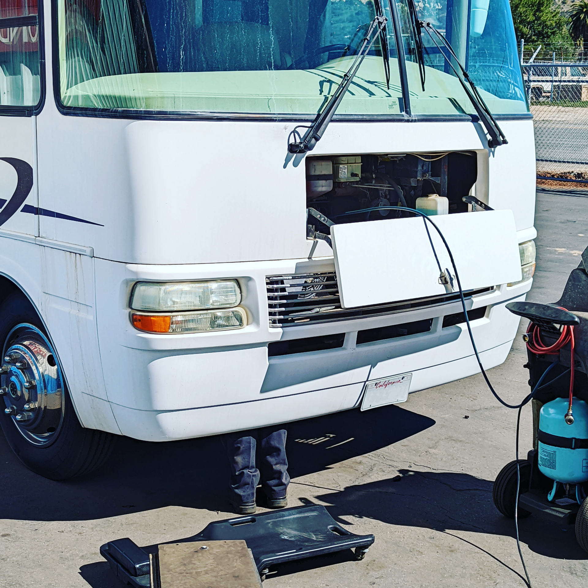 A white rv with the hood open is being worked on | Kirk's Radiator & Auto A/C Inc.