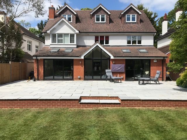 Patio and retaining red brick wall with step down incorporated.
