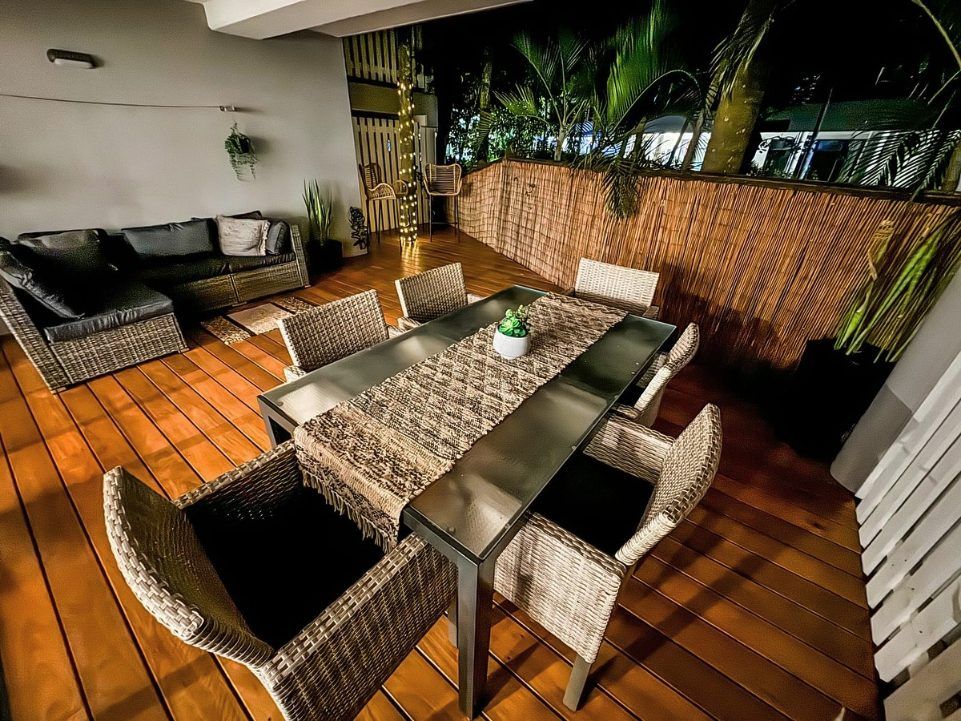 A Patio With a Table and Chairs and a Couch — Byron Bay Carpentry and Construction In Suffolk Park, NSW