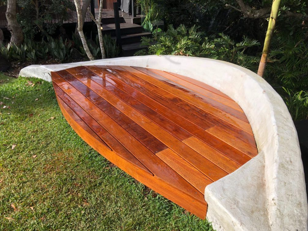 A Newly Renovated Boat-Shaped Deck in a Backyard Garden Space — Byron Bay Carpentry and Construction In Suffolk Park, NSW