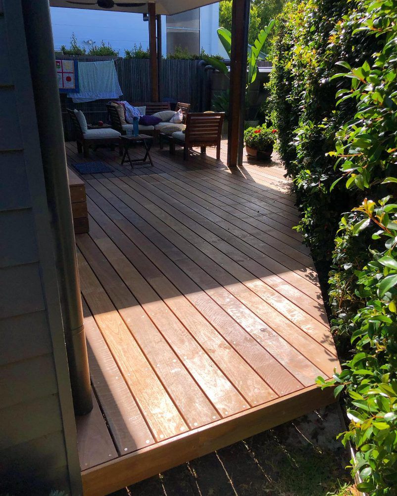 A Wooden Deck With a Lot of Furniture on It — Byron Bay Carpentry and Construction In Suffolk Park, NSW