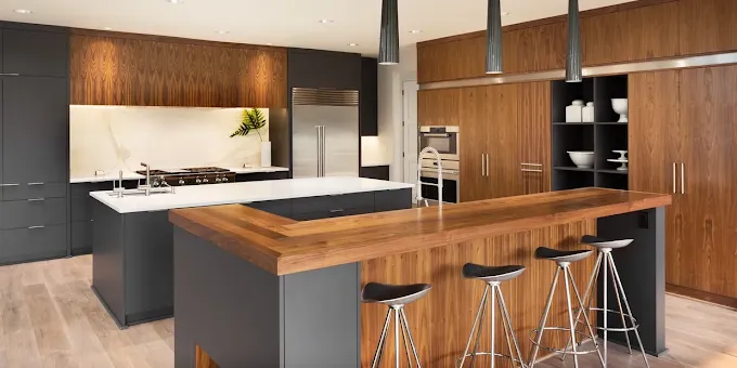 Modern kitchen with dark cabinets, wood accents, and a large island with bar stools.— Byron Bay Carpentry and Construction In Suffolk Park, NSW