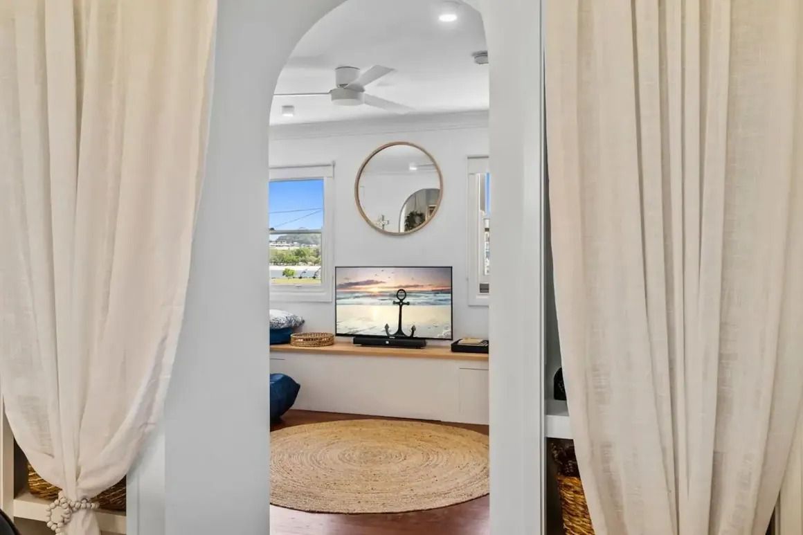A Living Room With a Television and a Mirror on the Wall — Byron Bay Carpentry and Construction In Suffolk Park, NSW