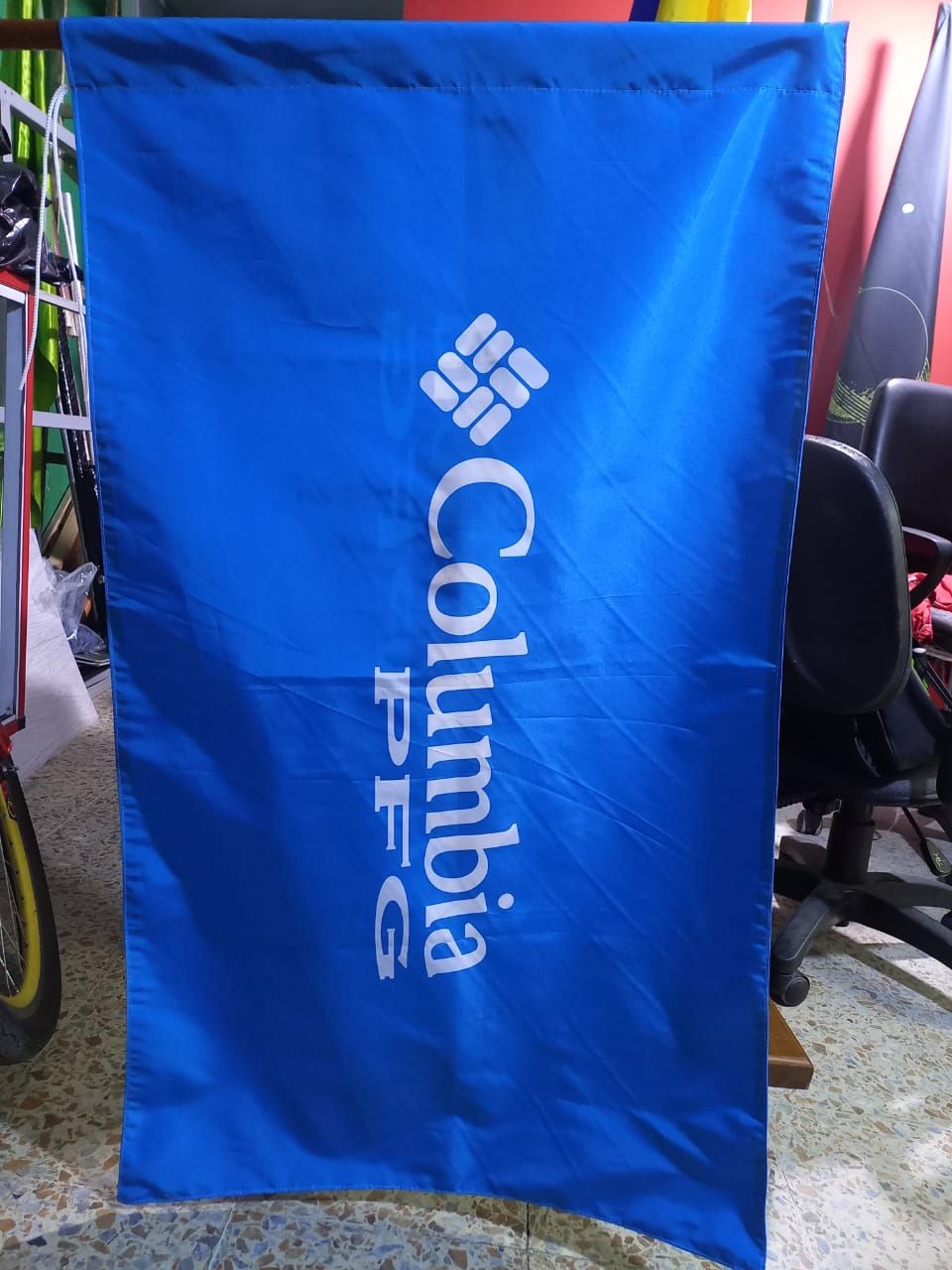 Blue Columbia PFG banner hanging outdoors with white logo and text
