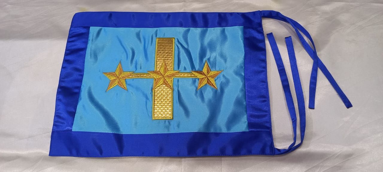 Blue satin banner with gold cross and stars on a white surface