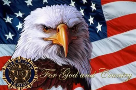 For God & Country A bald eagle stands in front of an American flag