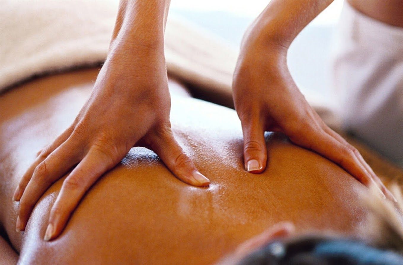 A Woman is Giving a Man a Massage on His Back