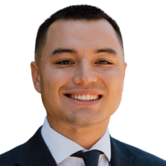 Smiling man in a suit and tie, headshot.