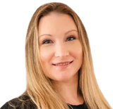 Woman with long blonde hair smiles at the camera.