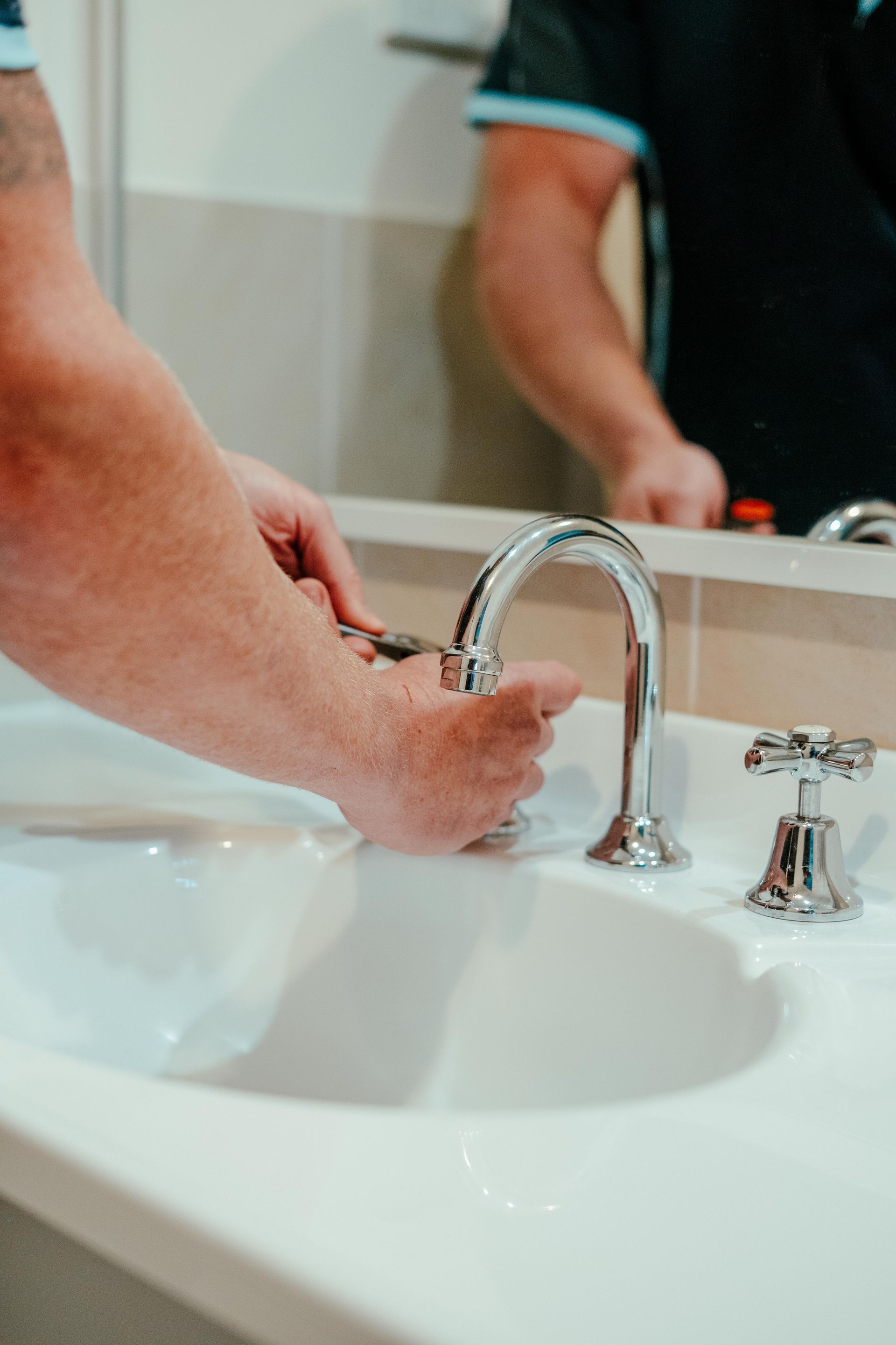 Aquafix plumber repairing a bathroom tap and mixer in a Southern Highlands home