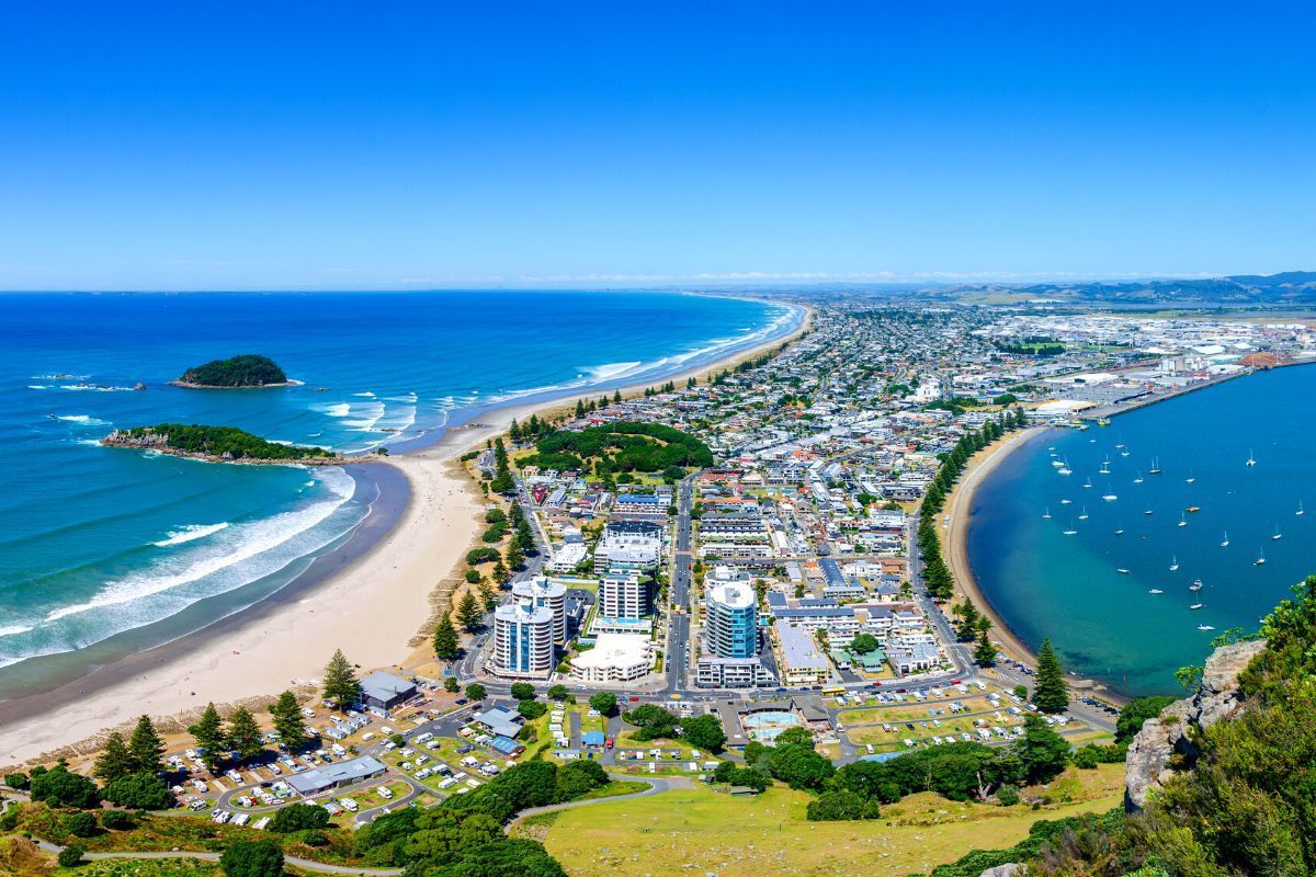 An aerial view of a city surrounded by water and a beach.