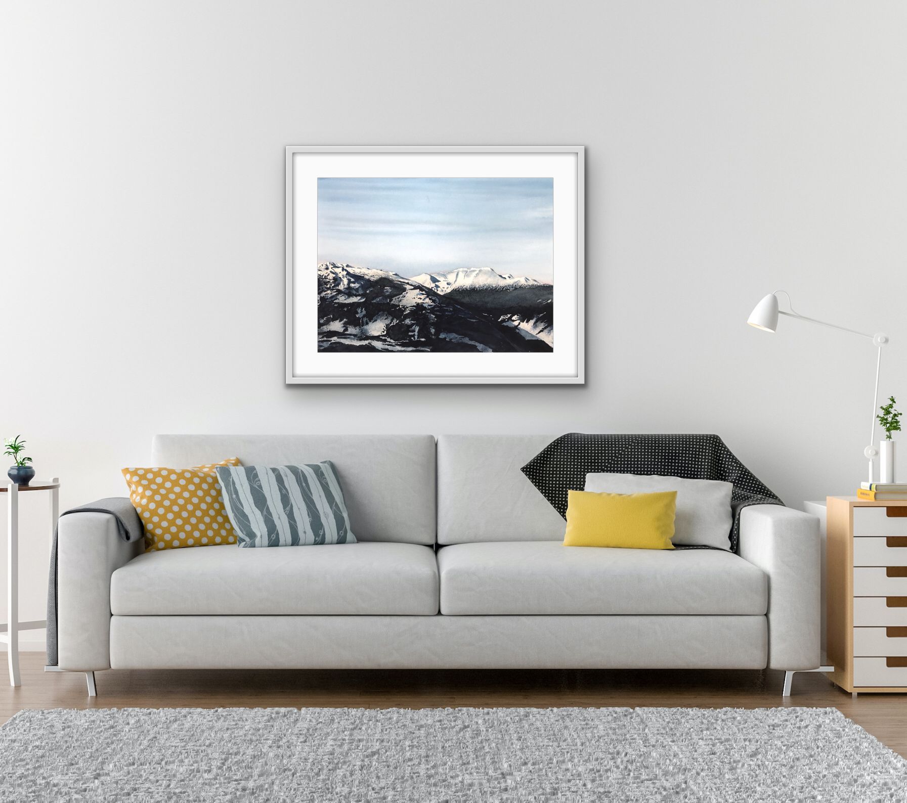 Modern living room with a gray sofa, patterned pillows, wall art, and a floor lamp.
