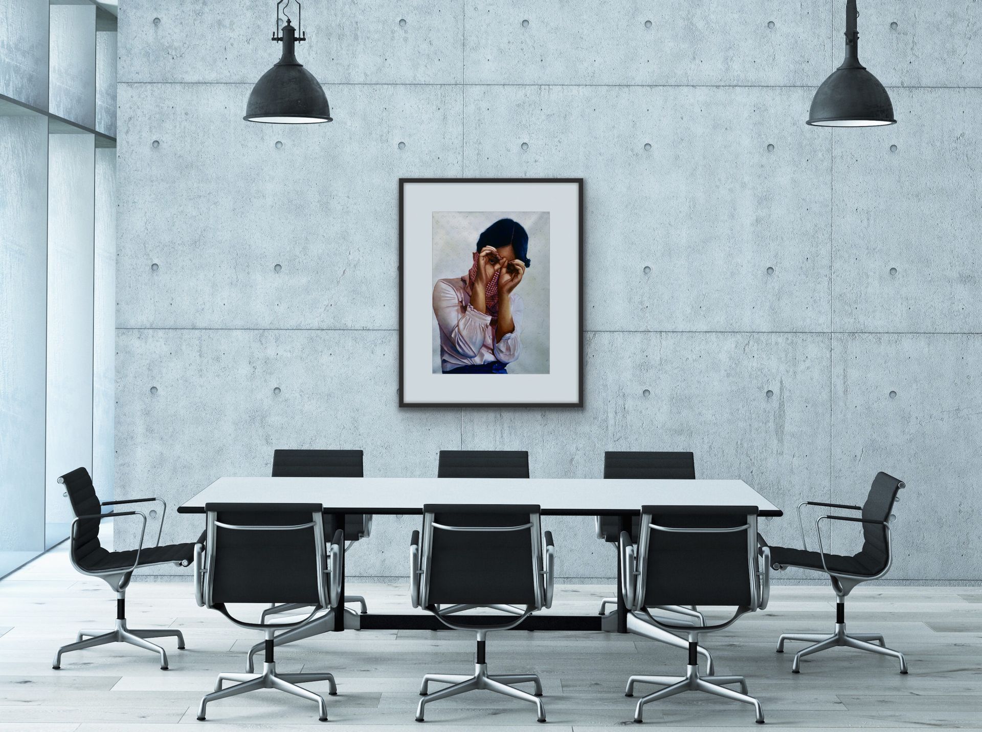 Minimal conference room with black chairs, white table, pendant lights, and a framed photo on a gray wall.