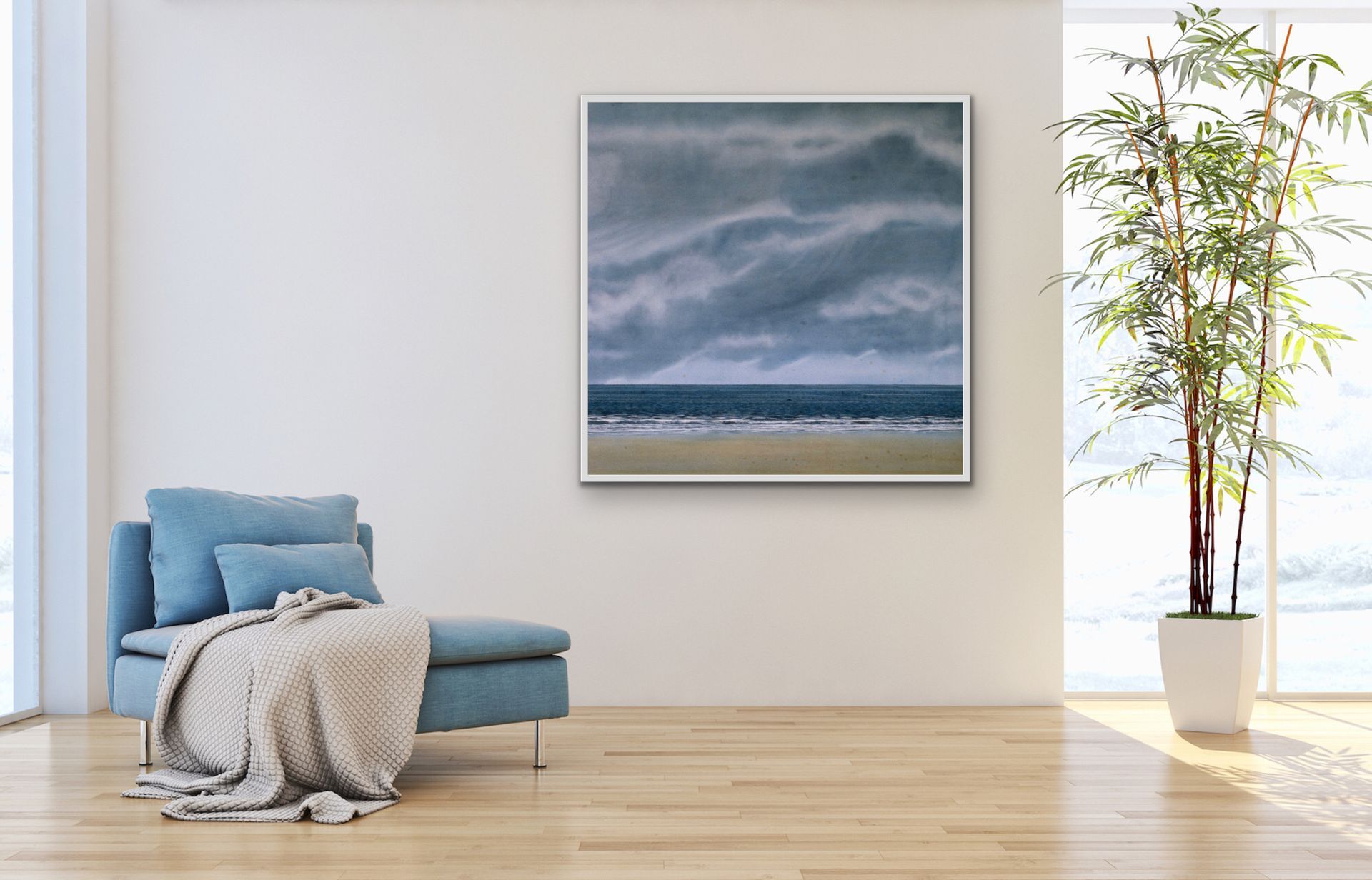 Minimal living room with blue chair, gray throw, wall art, and tall potted plant by a bright window