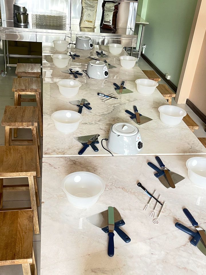 A long table with bowls and utensils on it.