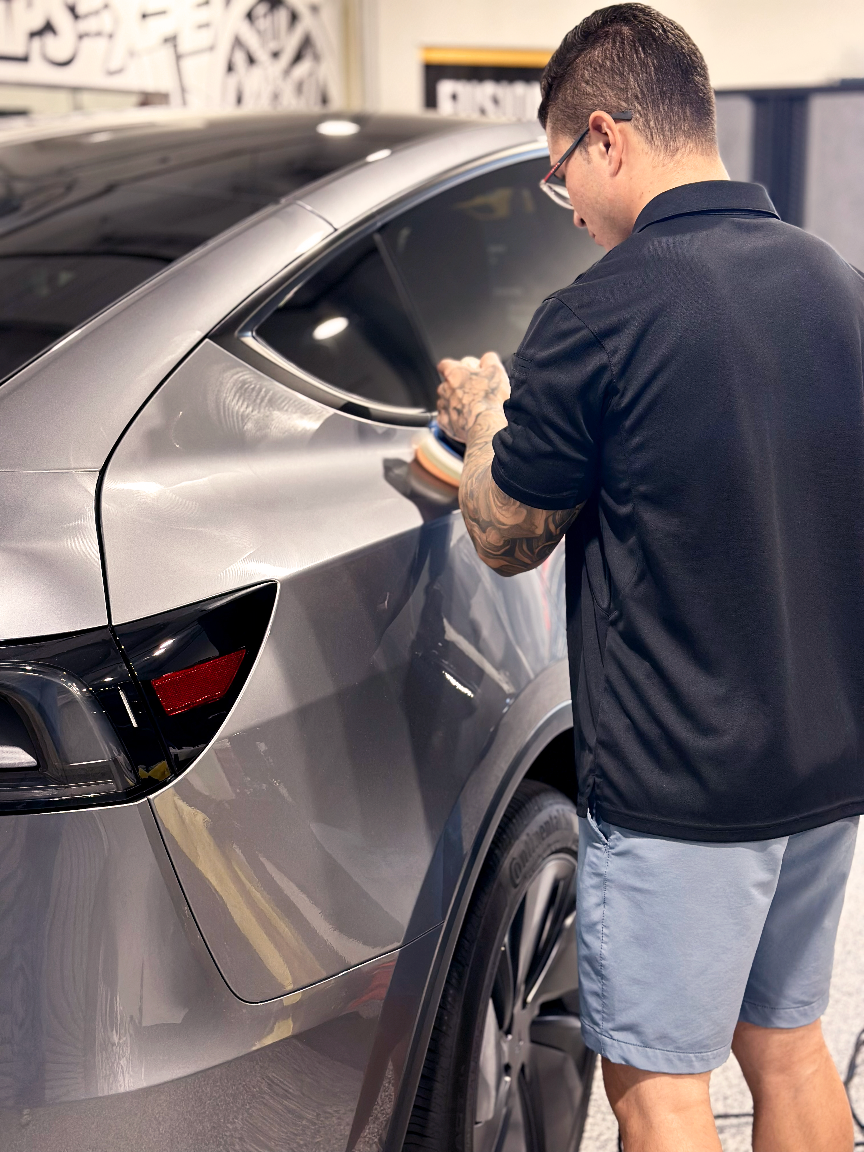 A blue sports car is parked on the side of the road.