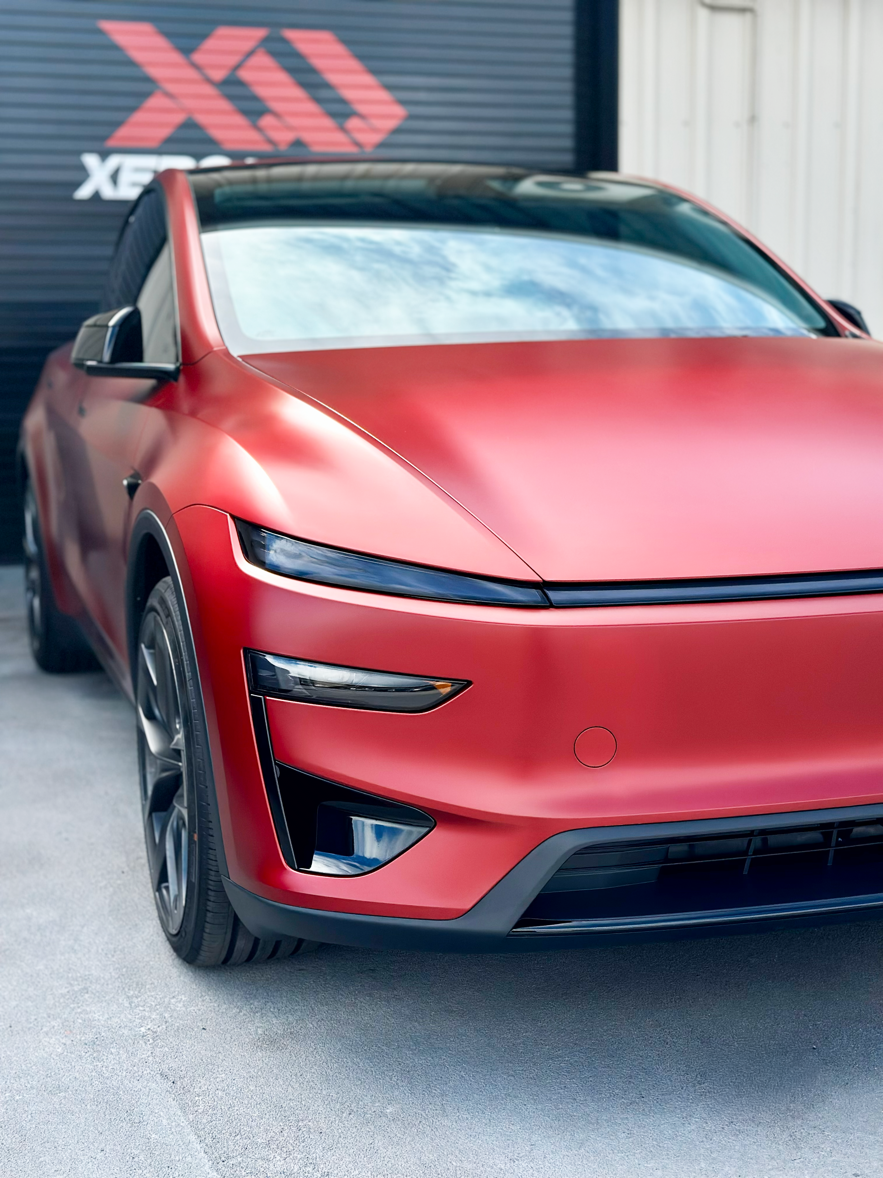 A white bmw m3 is parked in a garage.