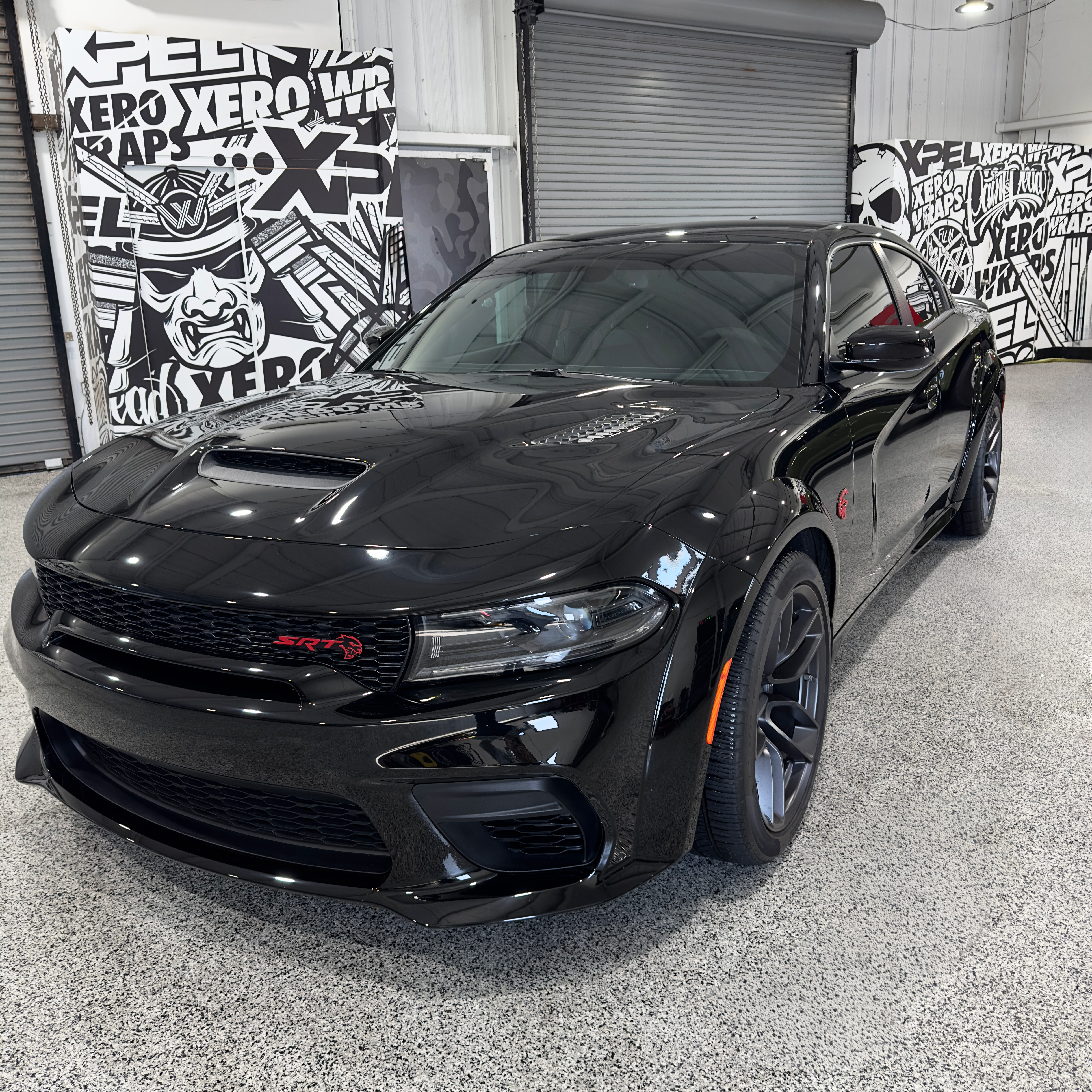A close up of a green car with a black grille
