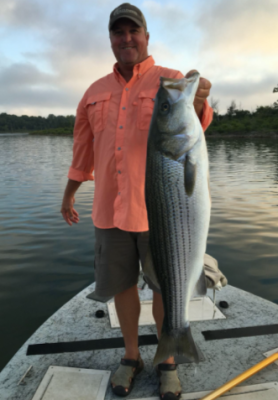 fisherman holding bass