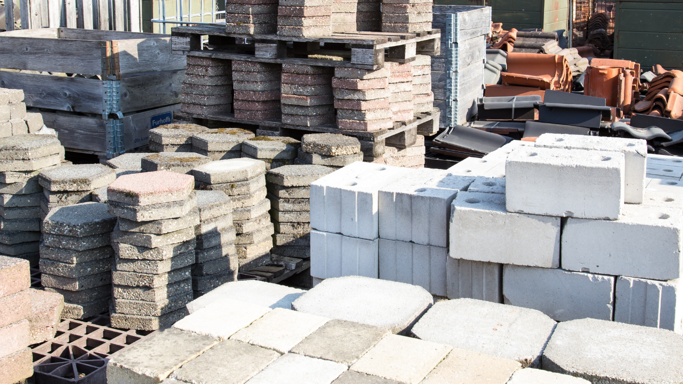 A bunch of bricks are stacked on top of each other in a pile.