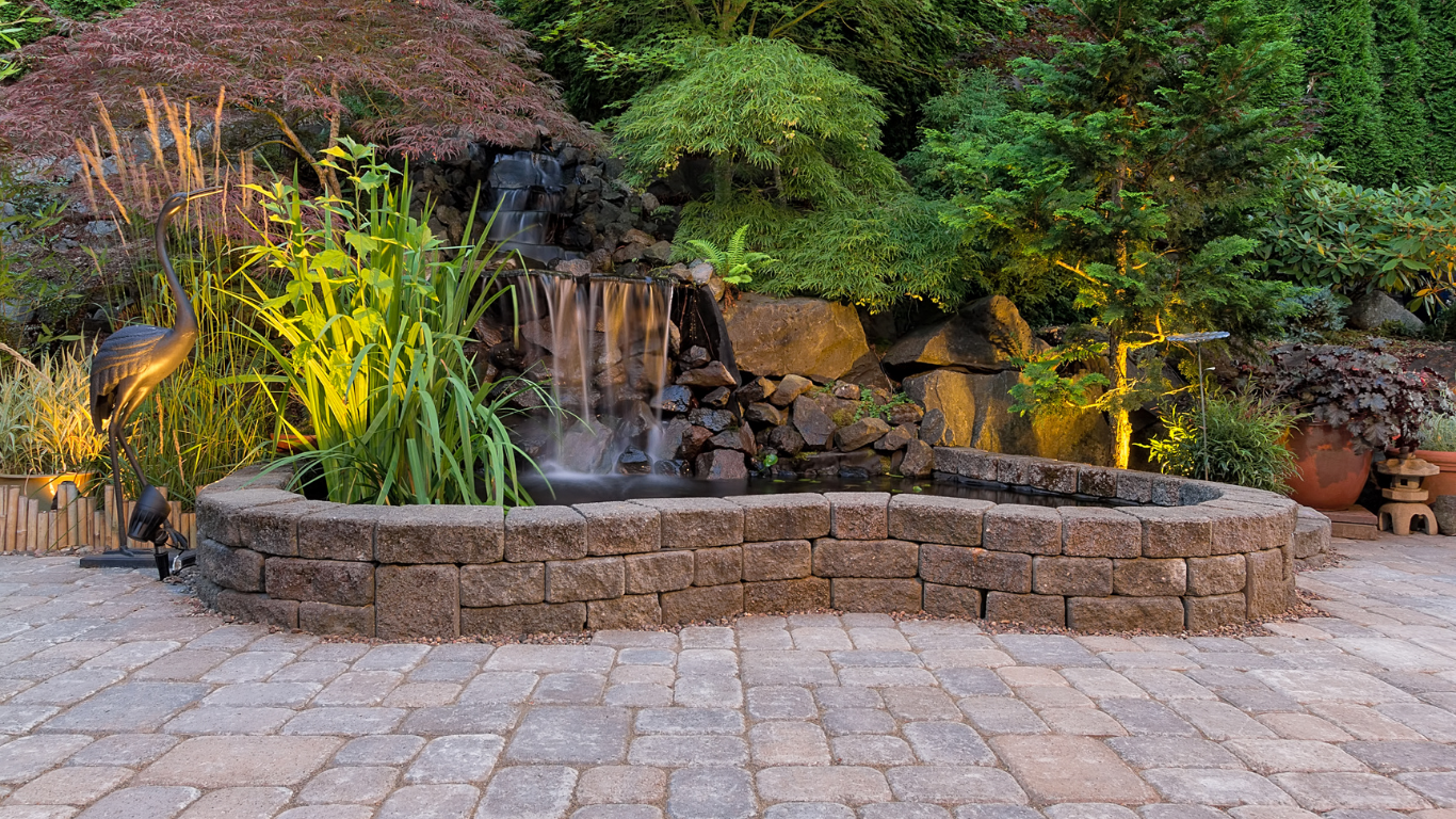 There is a waterfall in the middle of the patio.
