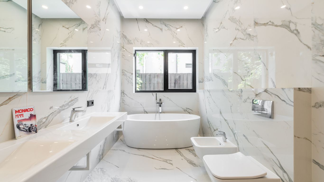 A bathroom with a bathtub , sink , toilet and mirror.