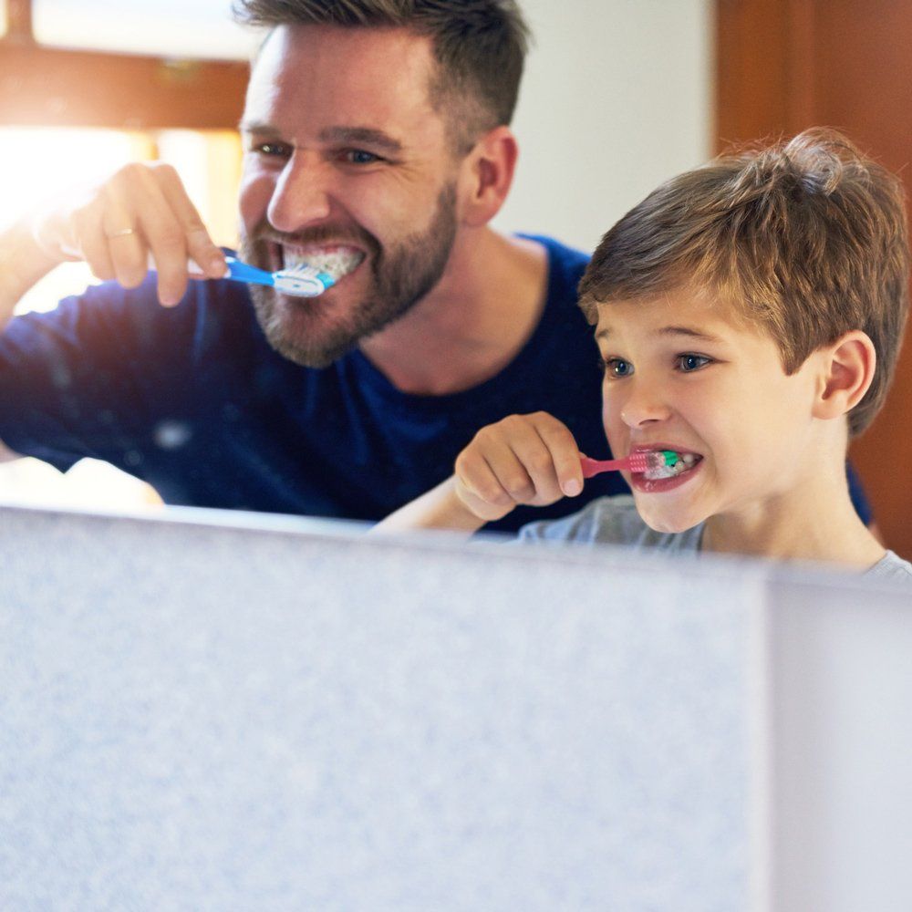 Father and Son Brushing Teeth — Sarasota, FL — Sterling Dental Father and Son Brushing Teeth — Sarasota, FL — Sterling Dental