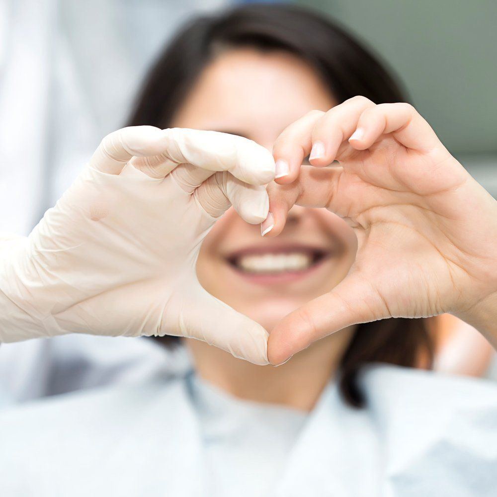 Dentist And Patient Heart Shape Using Hand — Sarasota, FL — Sterling Dental Dentist And Patient Heart Shape Using Hand — Sarasota, FL — Sterling Dental