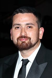 A man with a beard is wearing a suit and tie.
