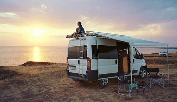 Woman Sitting On Roof Of An RV — Coventry, RI — Yonko's Buys RV's Woman Sitting On Roof Of An RV — Coventry, RI — Yonko's Buys RV's