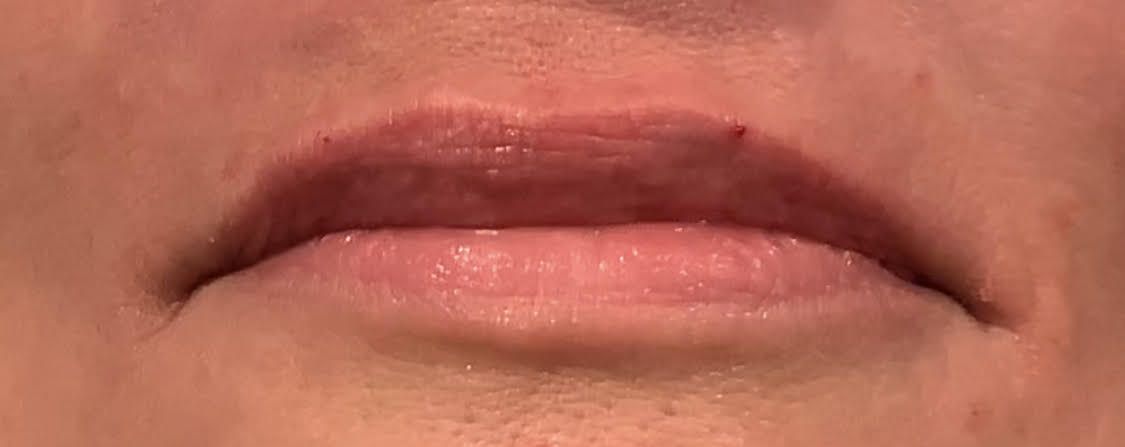 A close up of a woman 's forehead with her eyes closed.