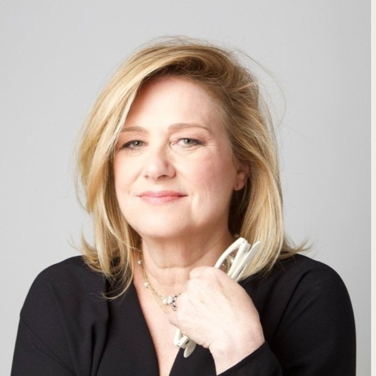 A woman in a black shirt is holding a pair of glasses