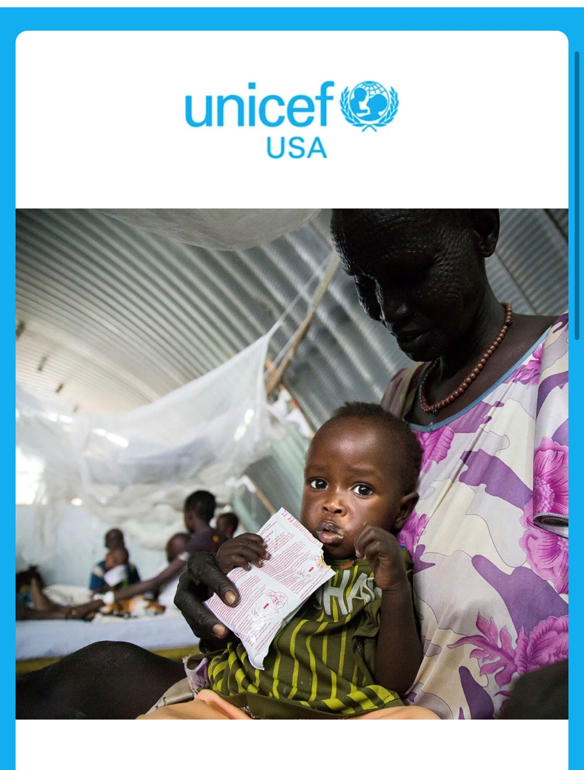 A woman is holding a baby with the unicef logo on the bottom