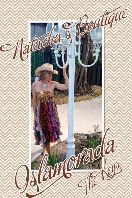 Woman in a patterned dress and hat standing by a white lamp post, with cursive text overlay.
