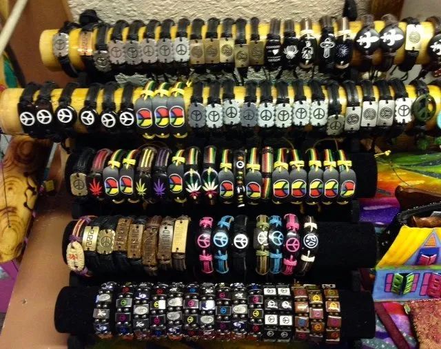 Rows of colorful beaded bracelets displayed on market stall racks