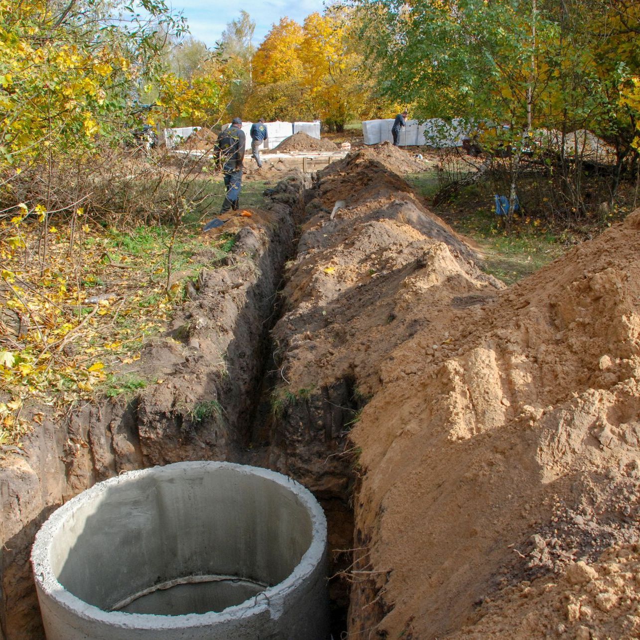 A hole in the ground with a concrete ring in it