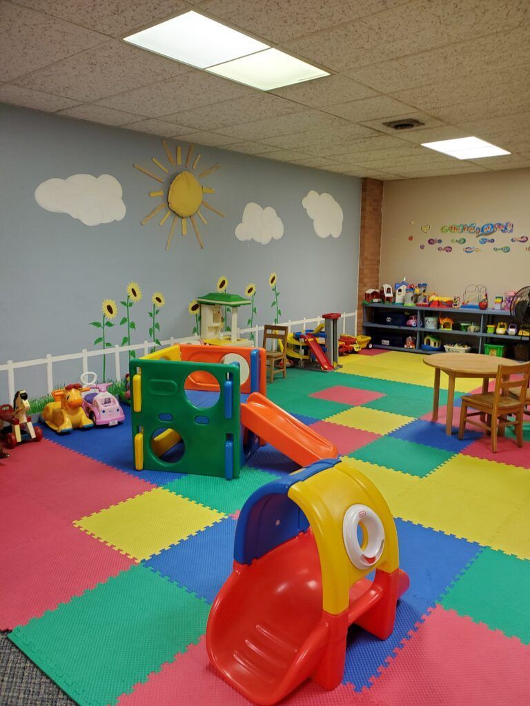A colorful play area with a slide and other toys