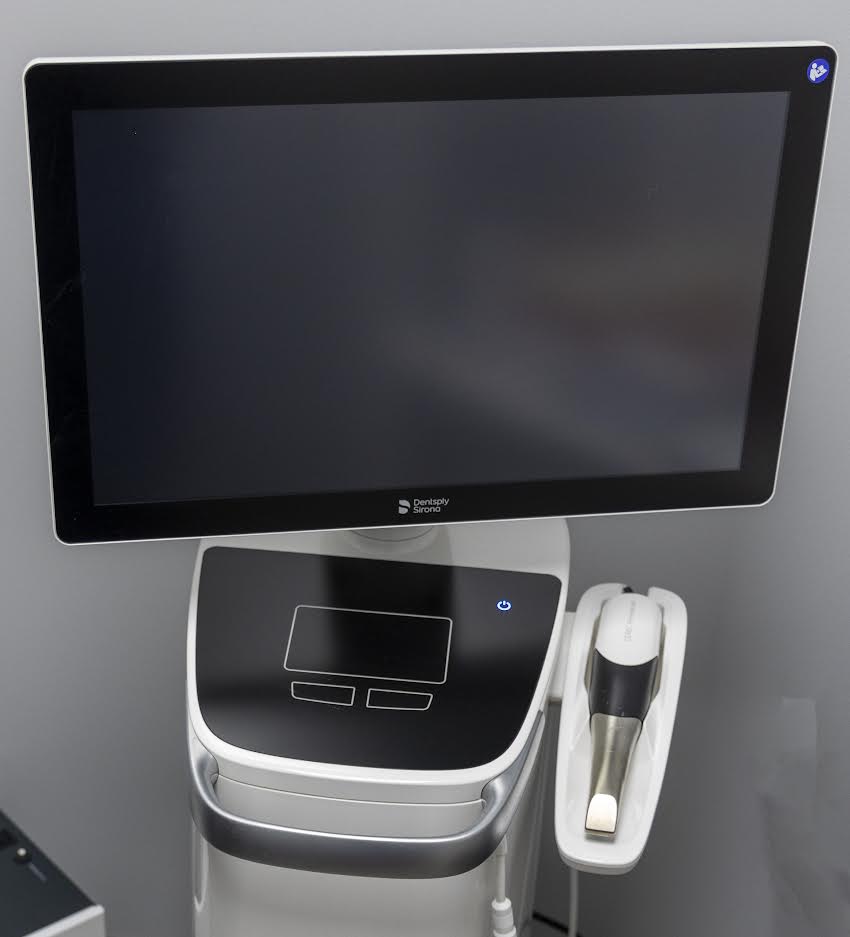 A computer monitor is sitting on top of a machine.