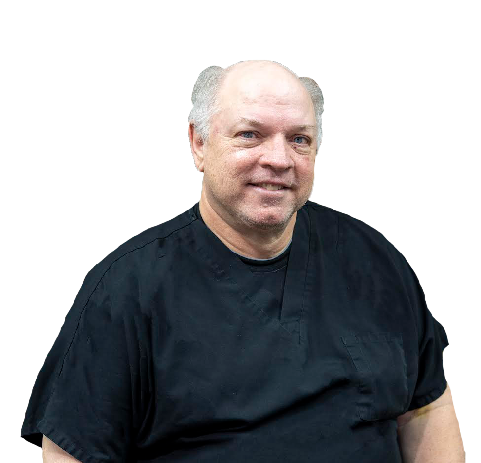 The man is wearing a black shirt and smiling for the camera.