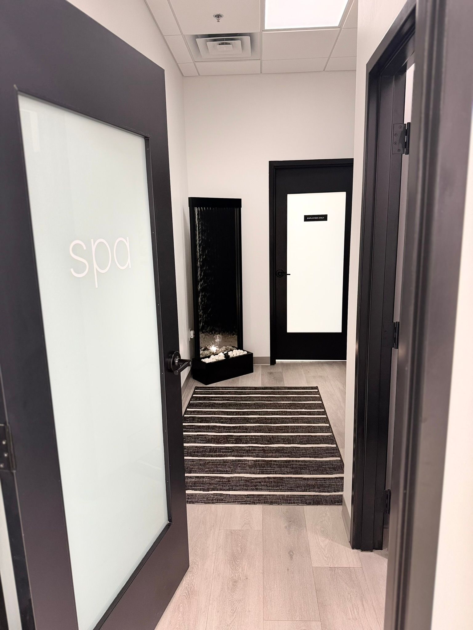 Hallway with frosted door labeled 