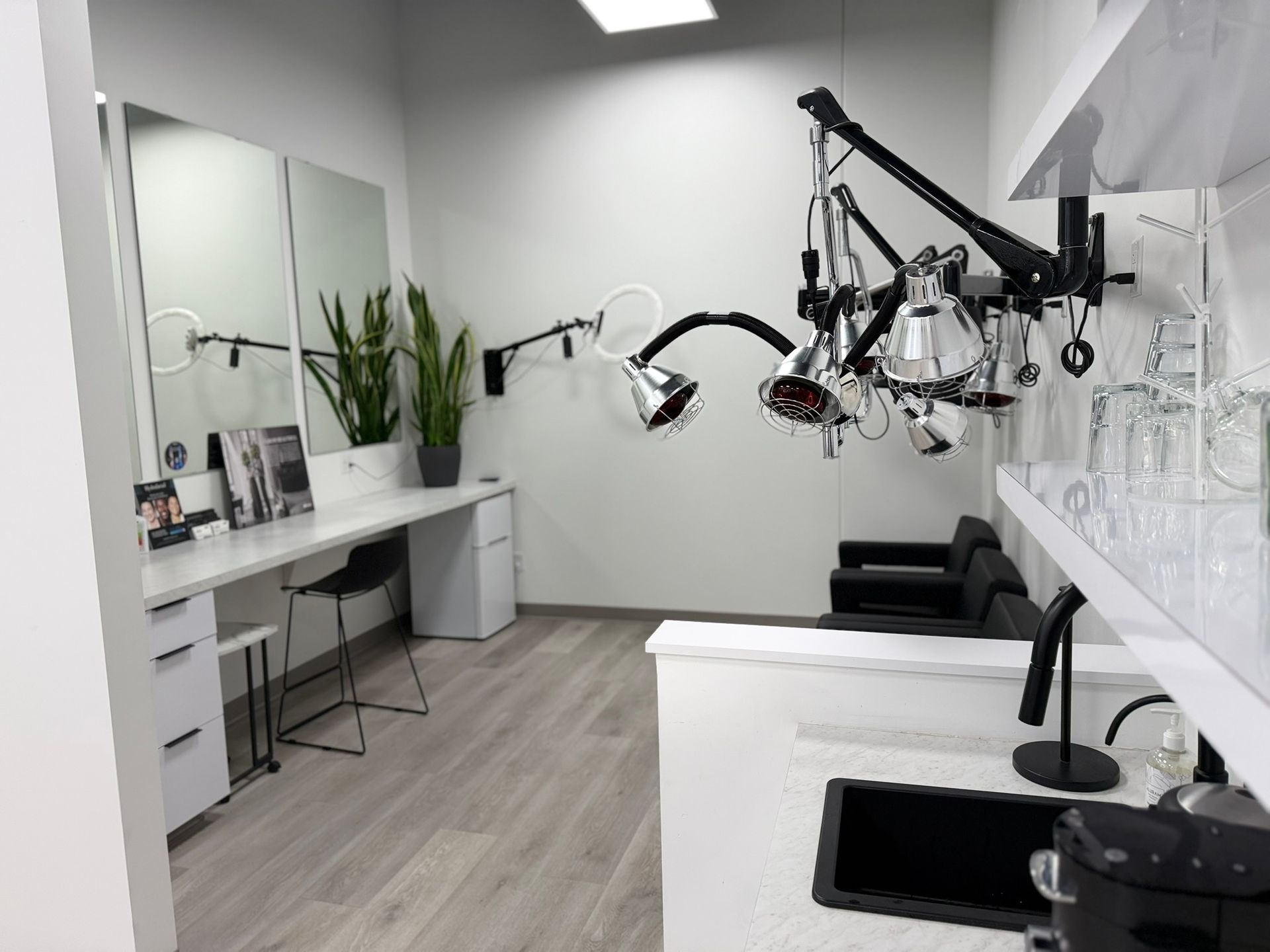 Hair salon interior with mirrors, styling chairs, and professional equipment.