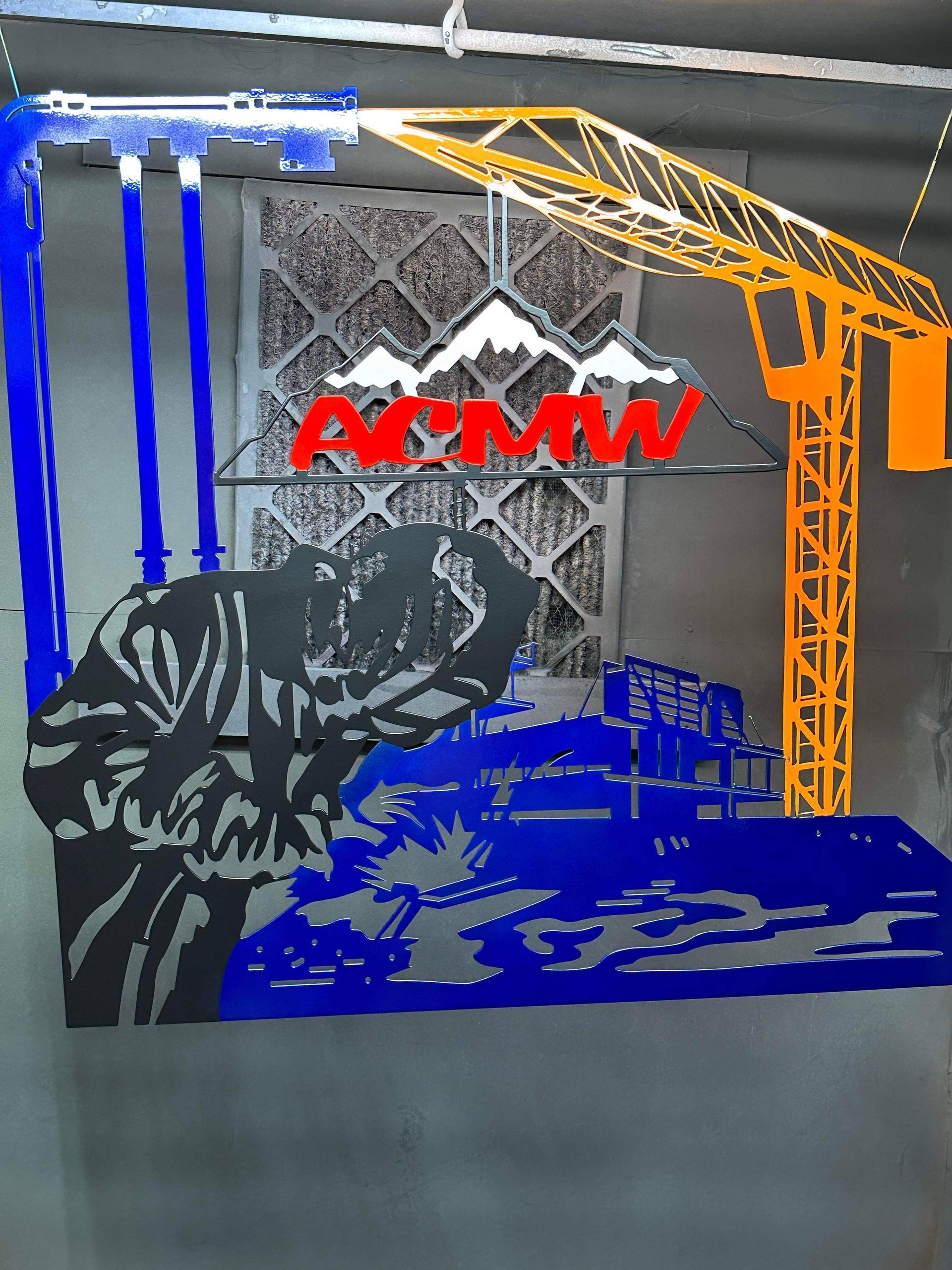 A metal sign featuring a welder, crane, and