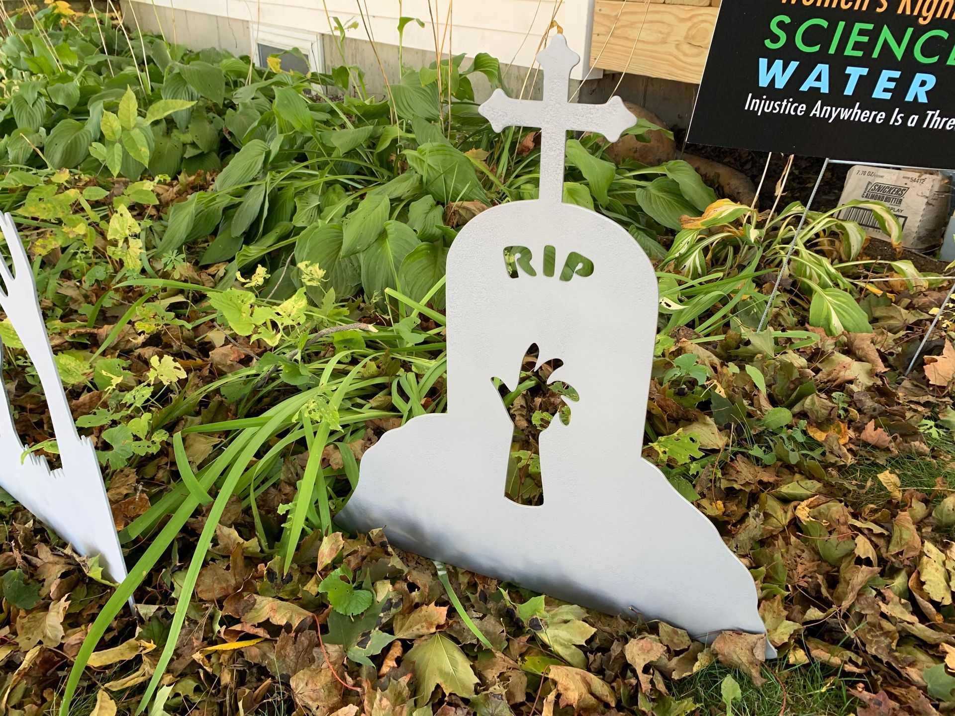A white tombstone decoration with a cross,