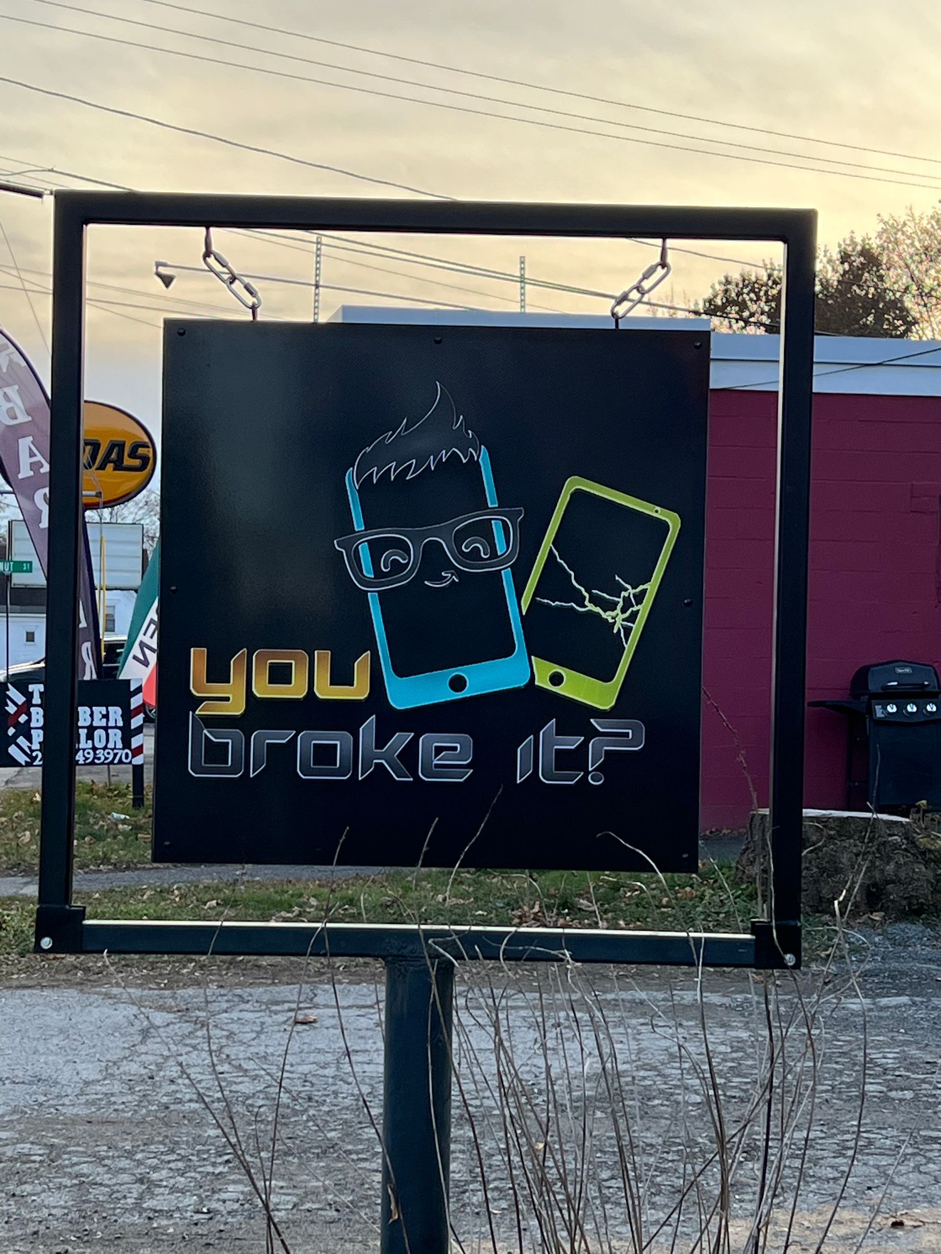 A black sign on a metal stand for