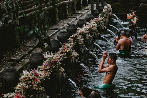 A group of people are standing in a pool of water.