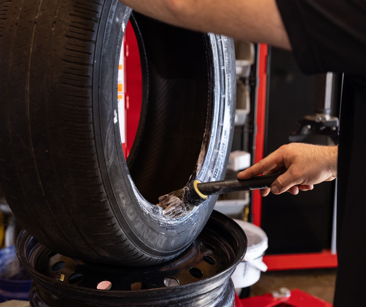 Technician Performing Tire Service In Auto Shop | Craig Automotive Services